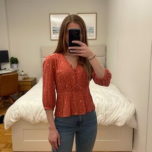 Elodie orange & white polka dot shirt. Size XS.